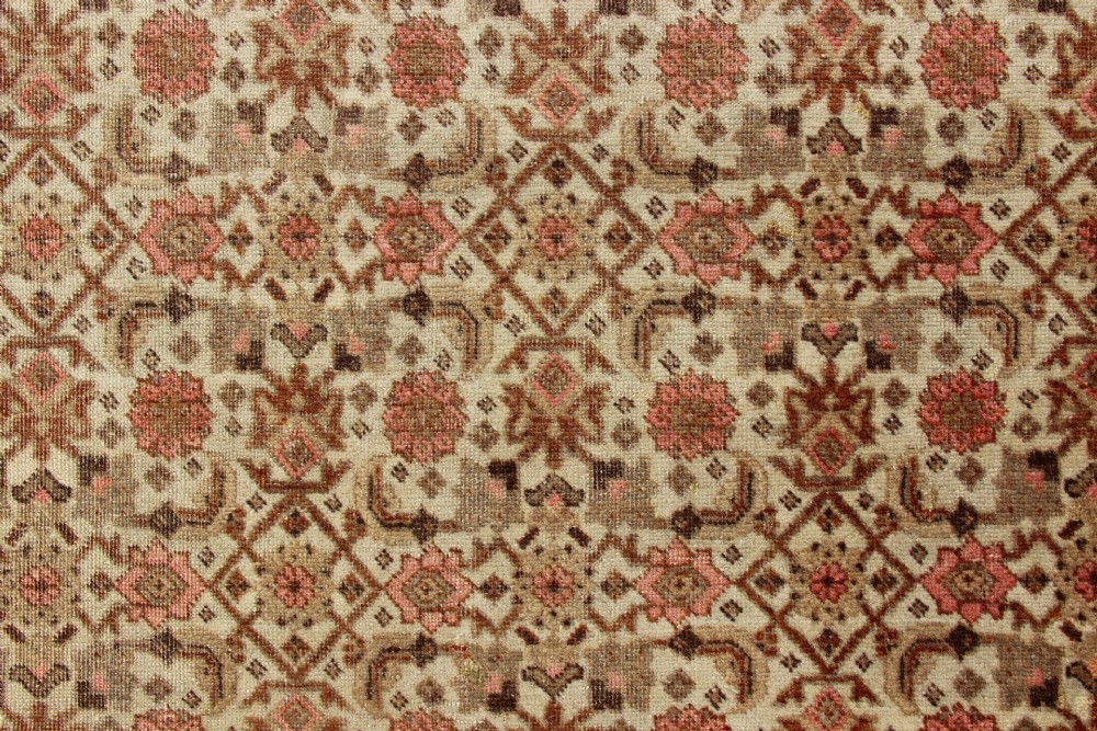 A large rectangular hand-knotted Persian Tabriz wool carpet featuring an all-over repeating geometric and floral pattern in terracotta, rust red, and beige framed by a complex multi-band border. View V