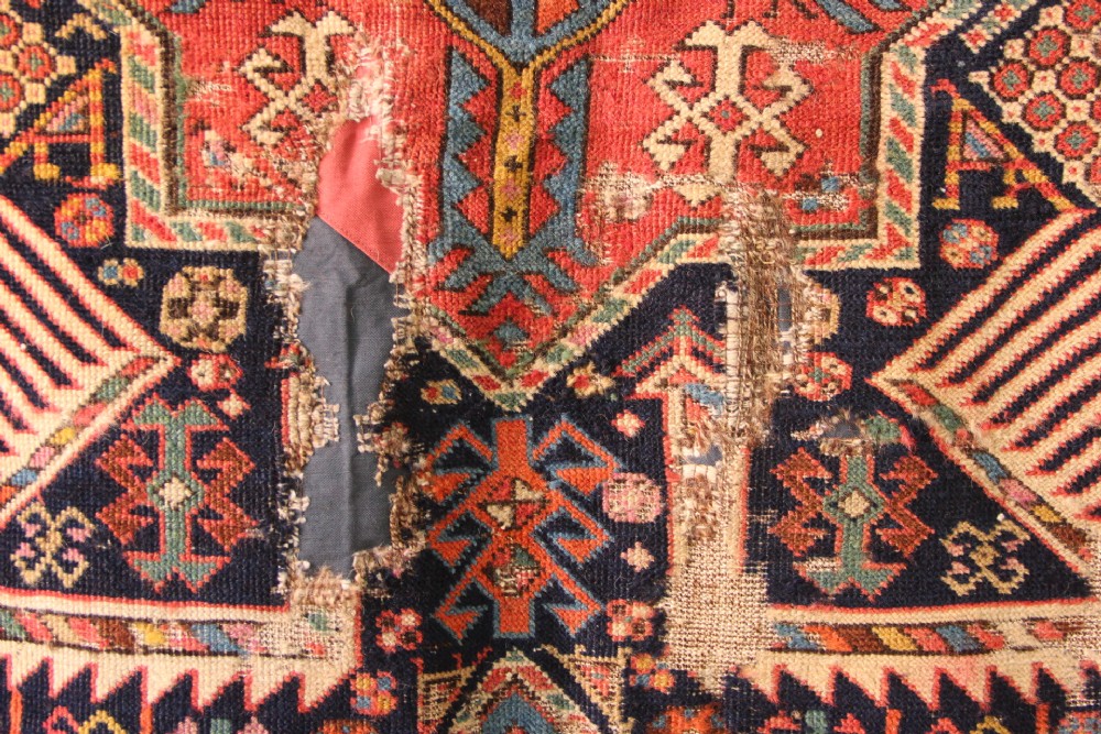 A long hand-knotted antique Caucasian Akstafa wool rug featuring geometric star medallions, stylized bird motifs, and a patterned border on a navy ground. View IV