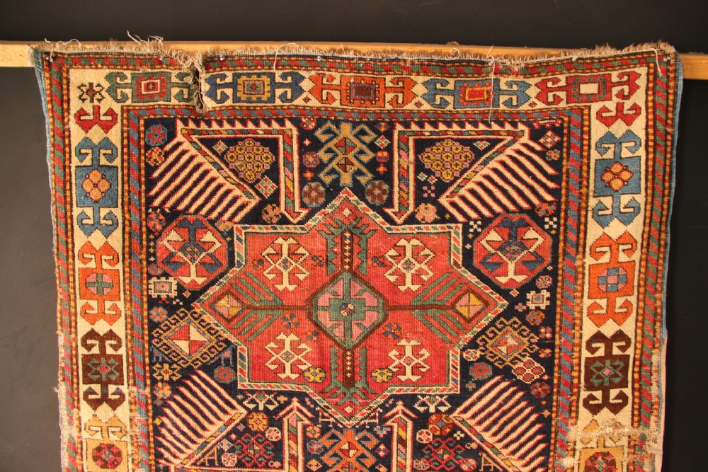 A long hand-knotted antique Caucasian Akstafa wool rug featuring geometric star medallions, stylized bird motifs, and a patterned border on a navy ground. View VIII