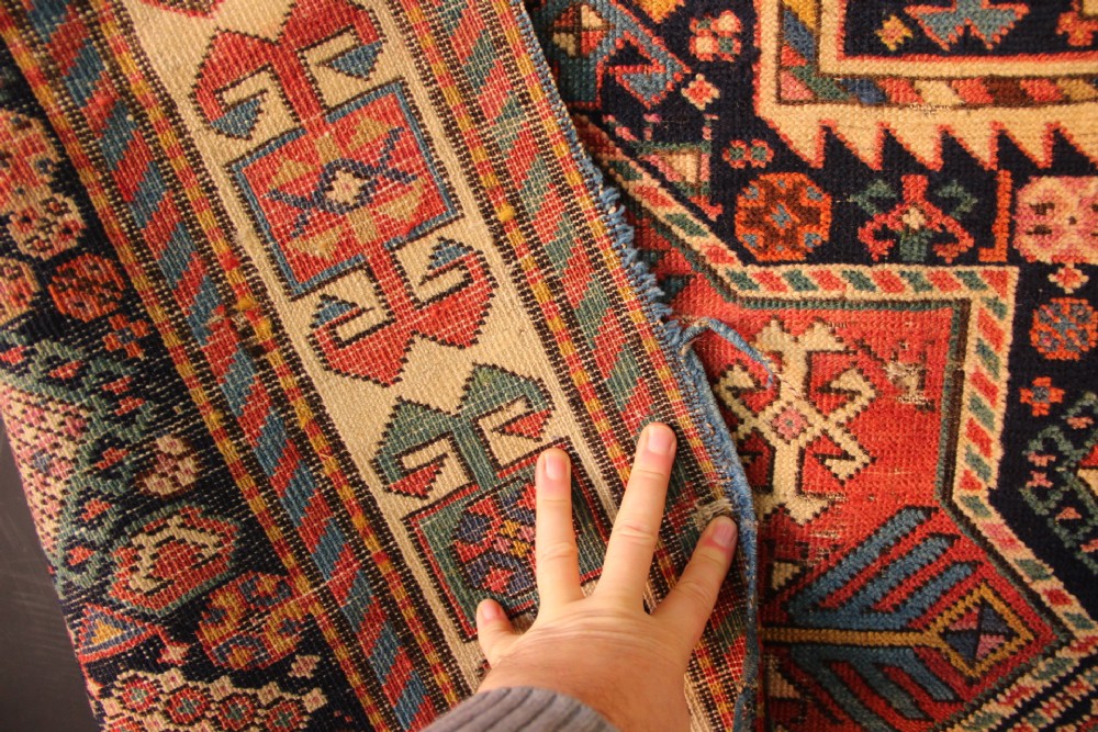 A long hand-knotted antique Caucasian Akstafa wool rug featuring geometric star medallions, stylized bird motifs, and a patterned border on a navy ground. View XI