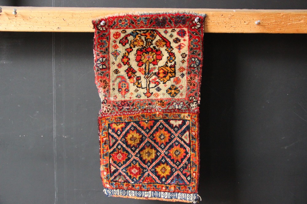 A handwoven antique Qashqai chanteh featuring red, navy blue, and cream wool with geometric diamond lattices and floral medallion patterns. View VII