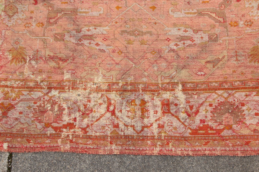An oversized antique Turkish Oushak wool carpet featuring soft apricot, terracotta, and cream tones with traditional botanical borders and motifs. View VIII