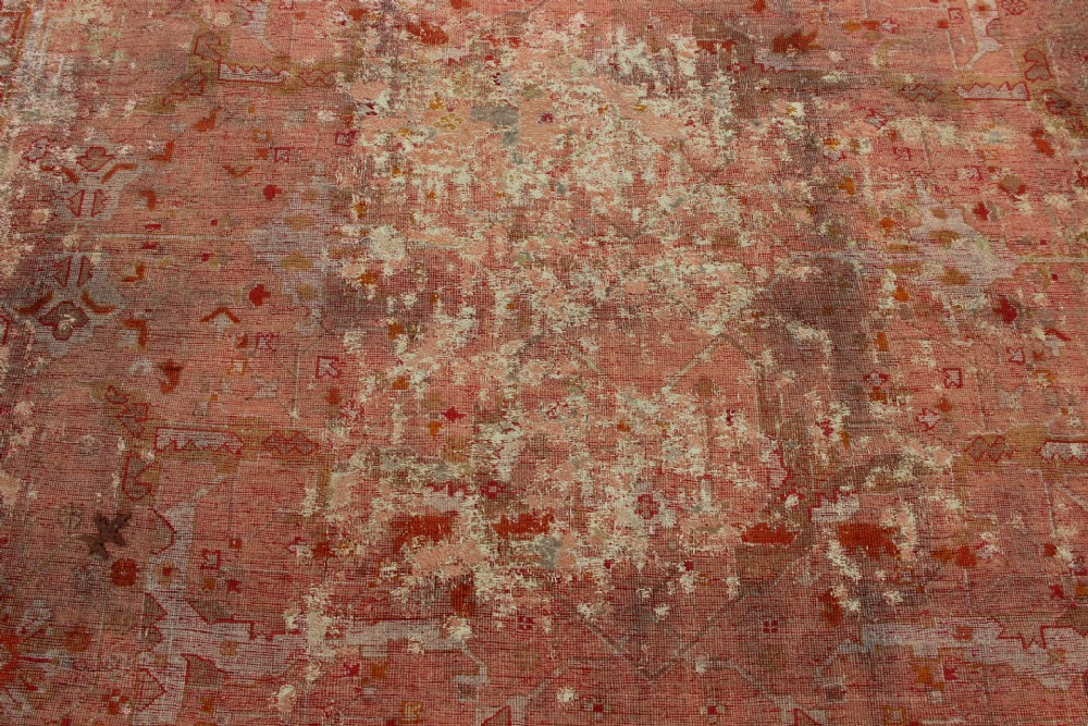 An oversized antique Turkish Oushak wool carpet featuring soft apricot, terracotta, and cream tones with traditional botanical borders and motifs. View XI