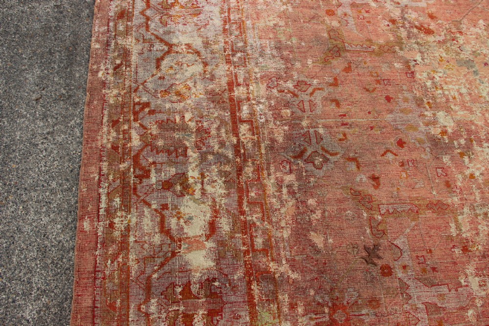 An oversized antique Turkish Oushak wool carpet featuring soft apricot, terracotta, and cream tones with traditional botanical borders and motifs. View XII