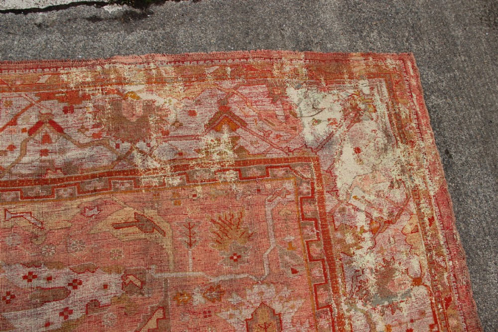 An oversized antique Turkish Oushak wool carpet featuring soft apricot, terracotta, and cream tones with traditional botanical borders and motifs. View XIV
