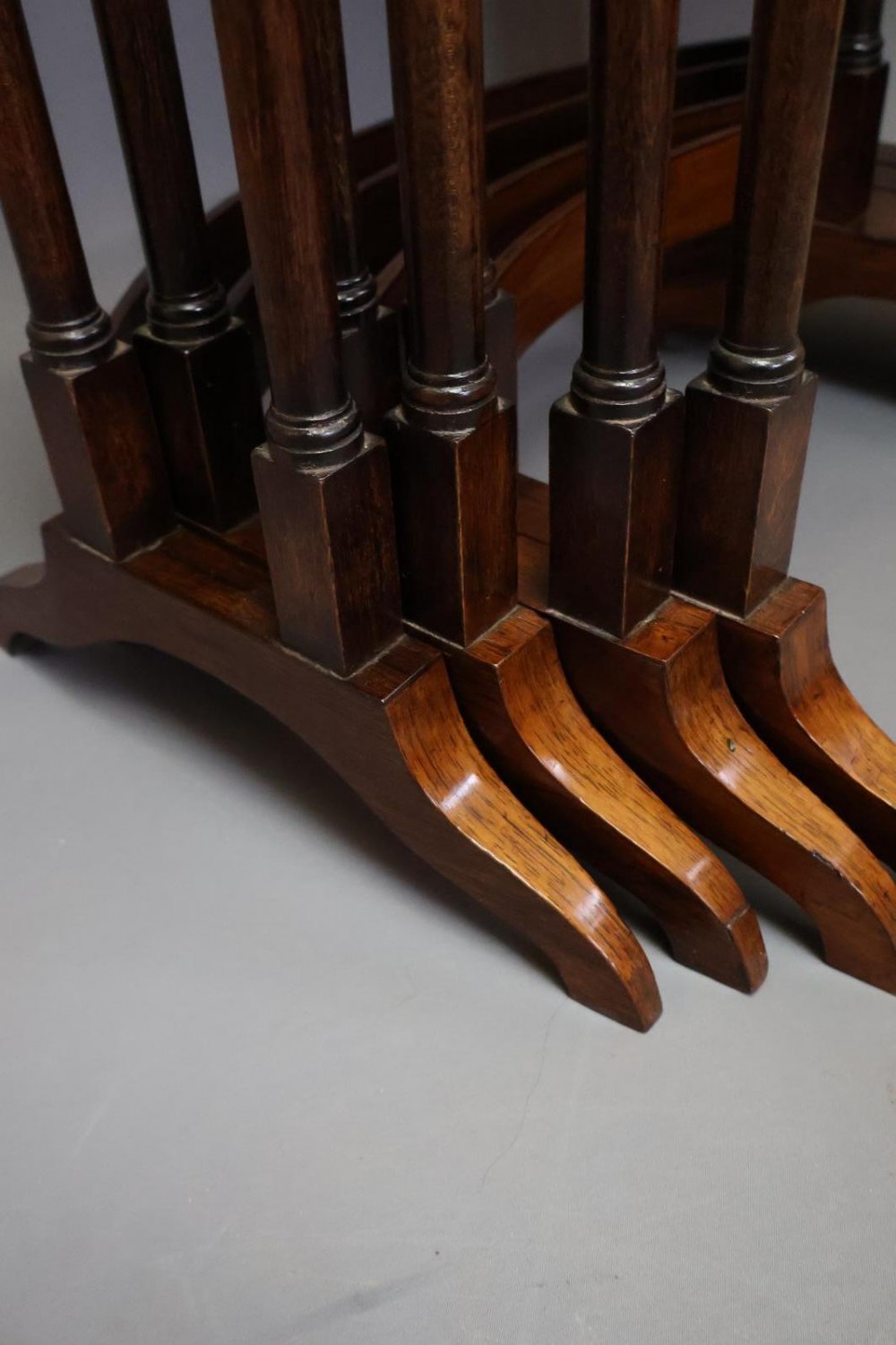A set of four nested Regency rosewood tables featuring rectangular tops, slender turned spindle legs, and curved lower stretchers. View VI