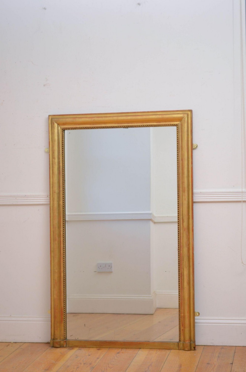 A large rectangular French antique wall mirror featuring a giltwood frame with fine bead moulding around the inner sight edge. View II
