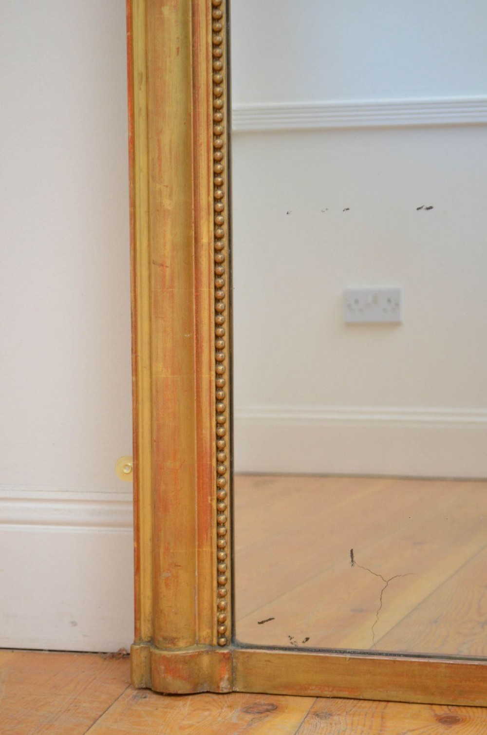 A large rectangular French antique wall mirror featuring a giltwood frame with fine bead moulding around the inner sight edge. View IV