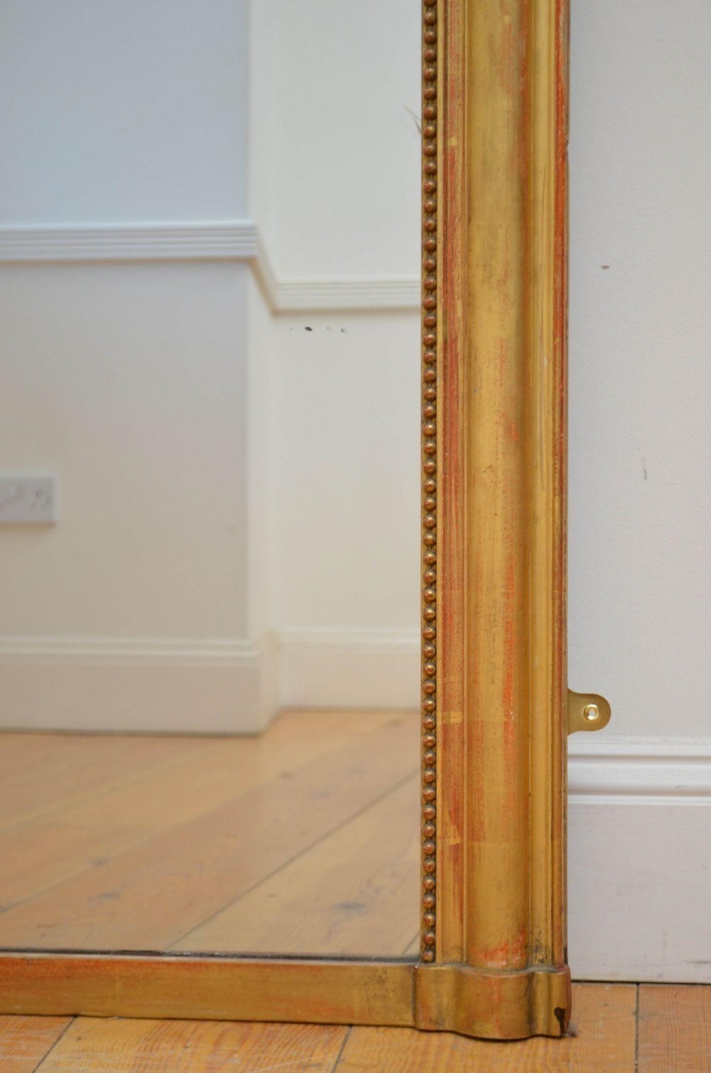 A large rectangular French antique wall mirror featuring a giltwood frame with fine bead moulding around the inner sight edge. View VIII