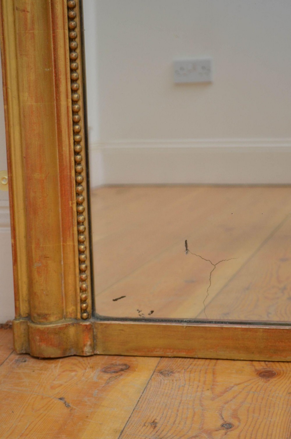 A large rectangular French antique wall mirror featuring a giltwood frame with fine bead moulding around the inner sight edge. View IX