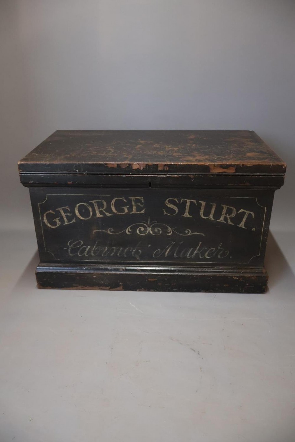 A Victorian painted wooden cabinet makers tool chest with hand-painted lettering on the front exterior and a mahogany fitted interior with geometric lid panelling. View II
