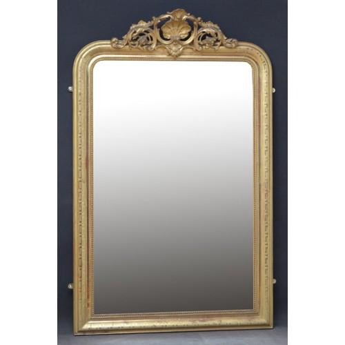 A 19th-century French wall mirror featuring a rectangular frame with rounded top corners, a gold leaf finish, and an ornate carved shell cresting.