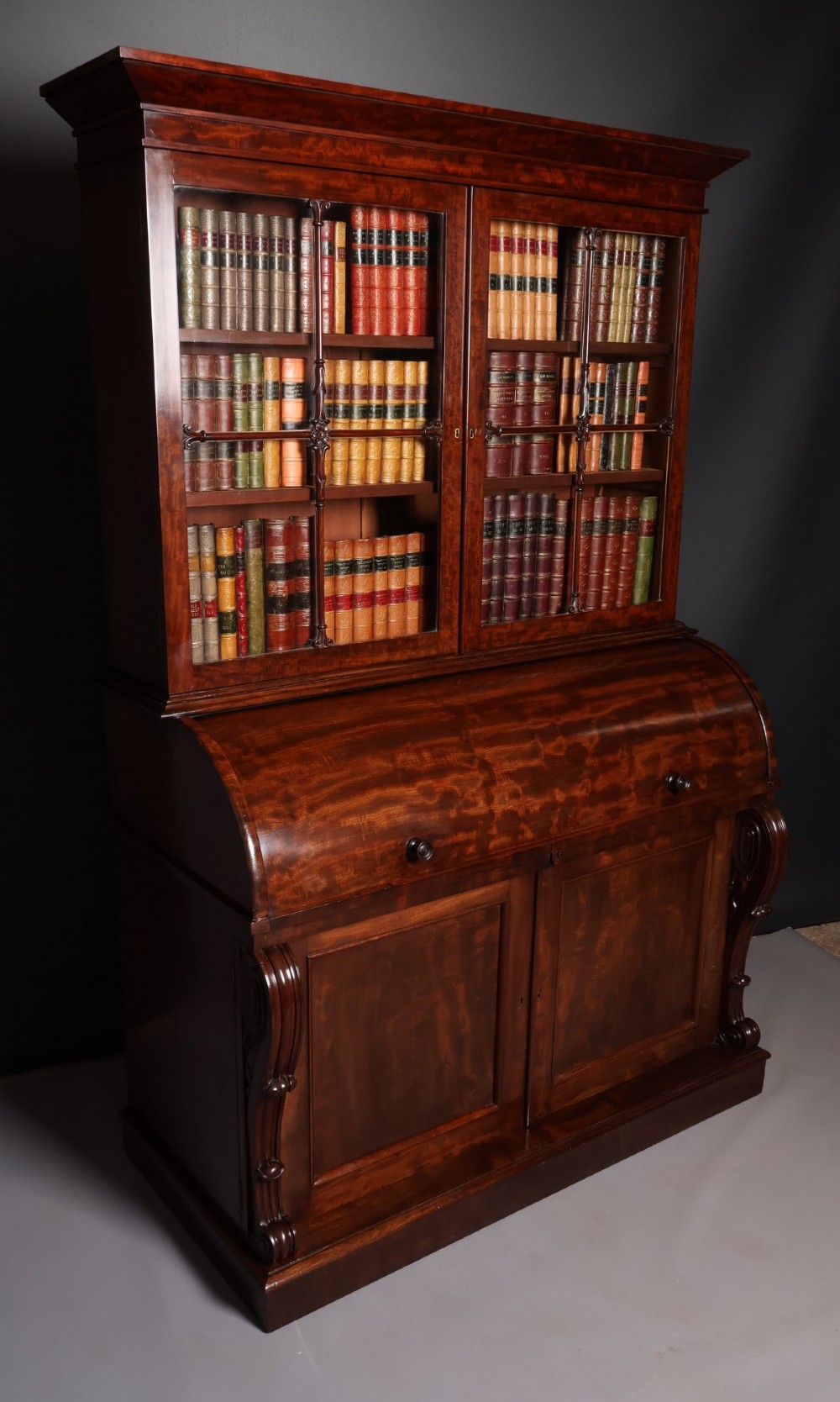 A William IV mahogany cylinder bureau bookcase featuring a two-door glazed upper cabinet, a rounded cylinder writing section, and lower cabinet doors. View III