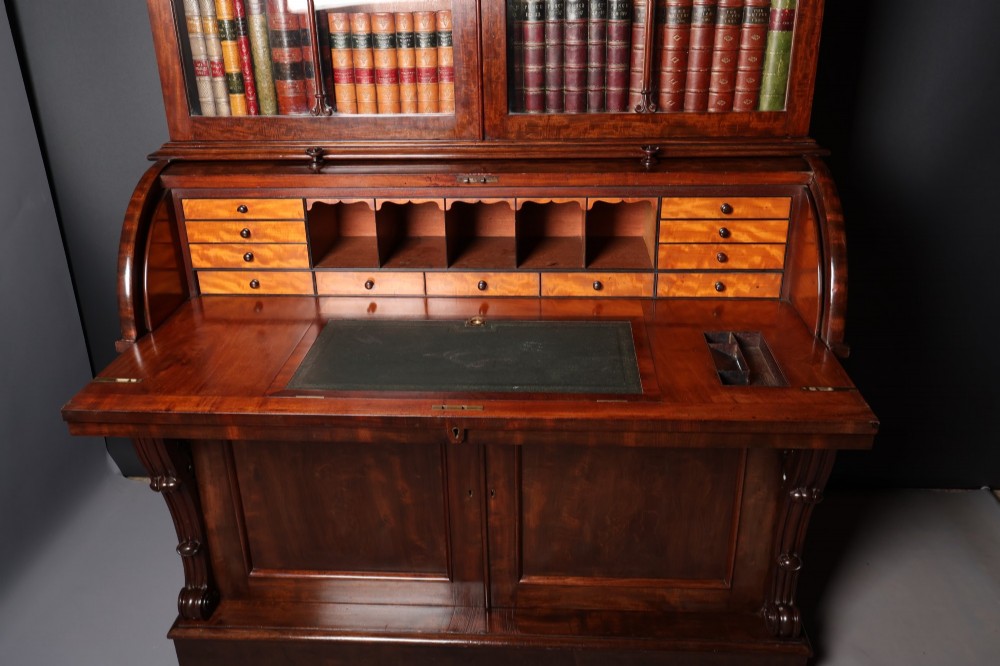 A William IV mahogany cylinder bureau bookcase featuring a two-door glazed upper cabinet, a rounded cylinder writing section, and lower cabinet doors. View IV