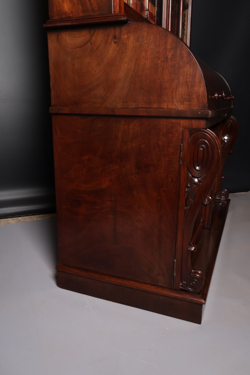 A William IV mahogany cylinder bureau bookcase featuring a two-door glazed upper cabinet, a rounded cylinder writing section, and lower cabinet doors. View VII
