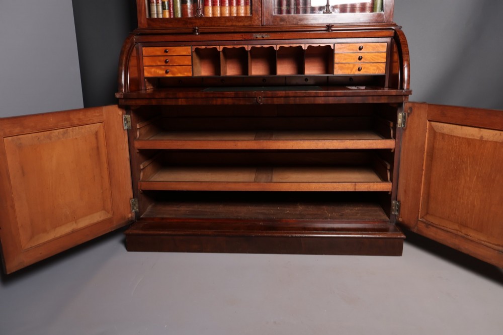 A William IV mahogany cylinder bureau bookcase featuring a two-door glazed upper cabinet, a rounded cylinder writing section, and lower cabinet doors. View X