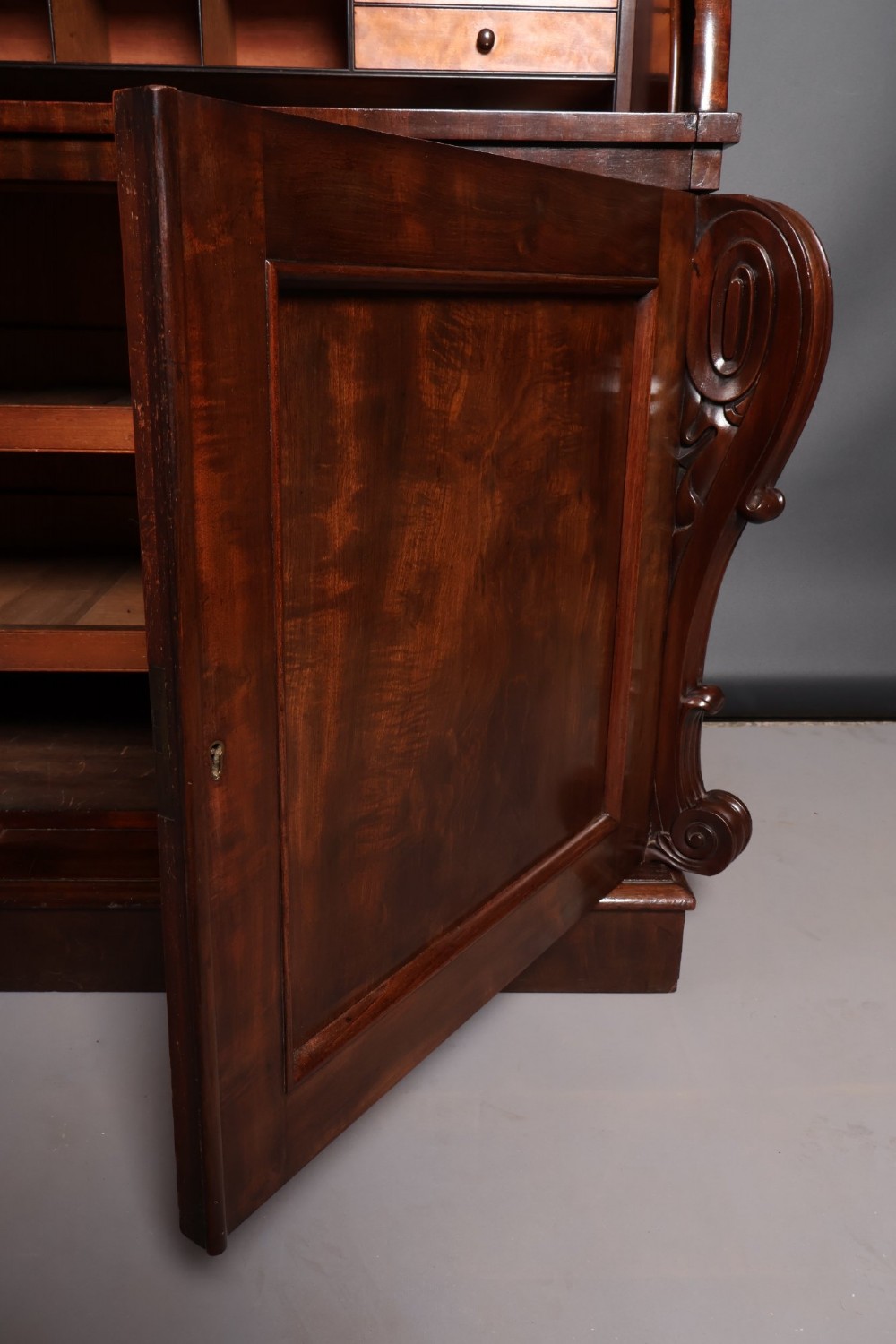 A William IV mahogany cylinder bureau bookcase featuring a two-door glazed upper cabinet, a rounded cylinder writing section, and lower cabinet doors. View XI