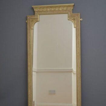 A tall, rectangular Victorian giltwood pier mirror featuring a stepped cresting cornice, beaded moulding, and arched upper frame profile. View II