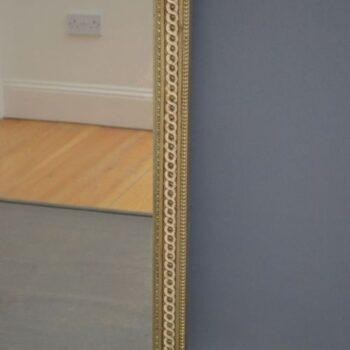 A tall, rectangular Victorian giltwood pier mirror featuring a stepped cresting cornice, beaded moulding, and arched upper frame profile. View X