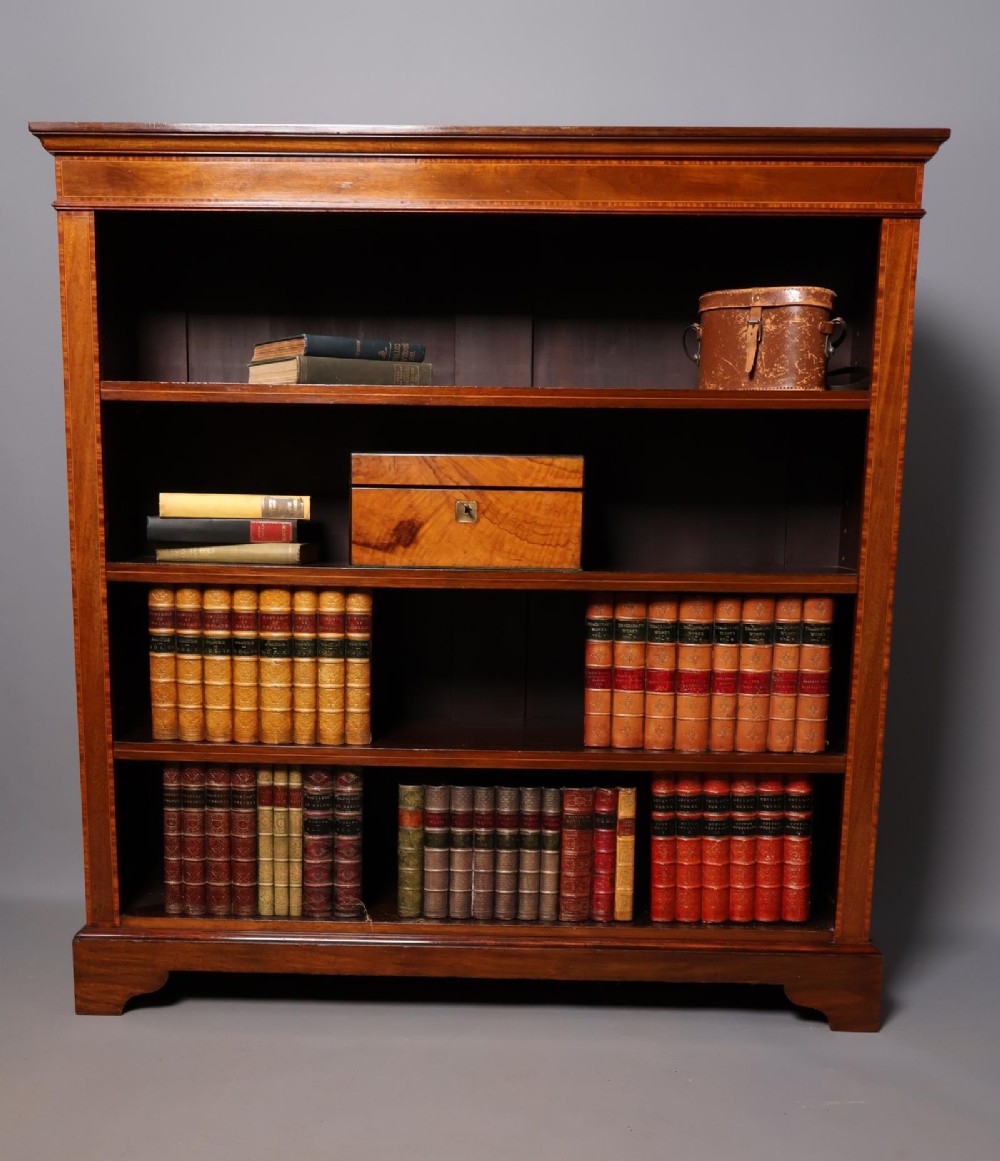 An Edwardian open-front mahogany bookcase featuring four wide shelves and decorative inlaid borders along the frame. View II