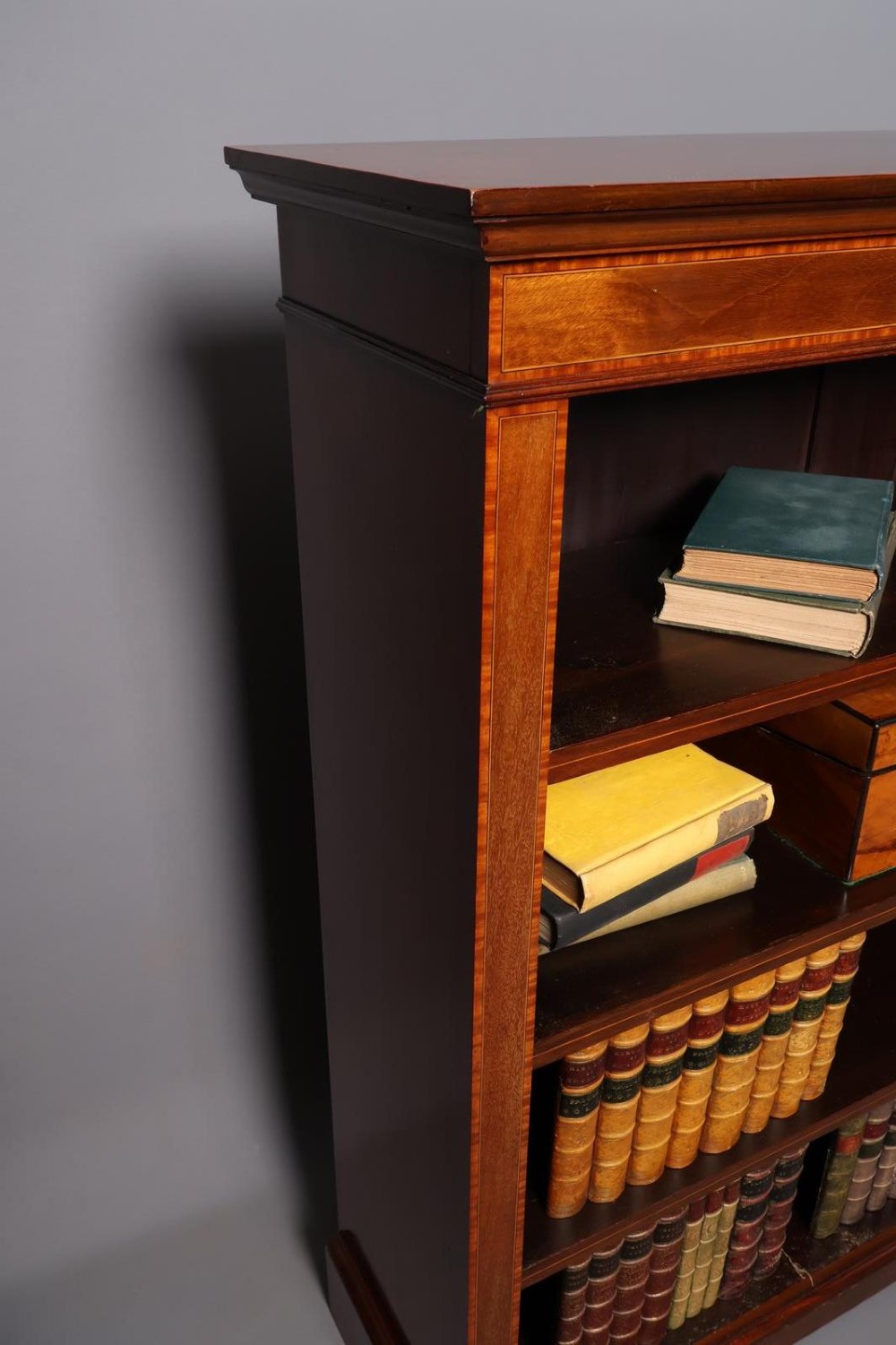An Edwardian open-front mahogany bookcase featuring four wide shelves and decorative inlaid borders along the frame. View III