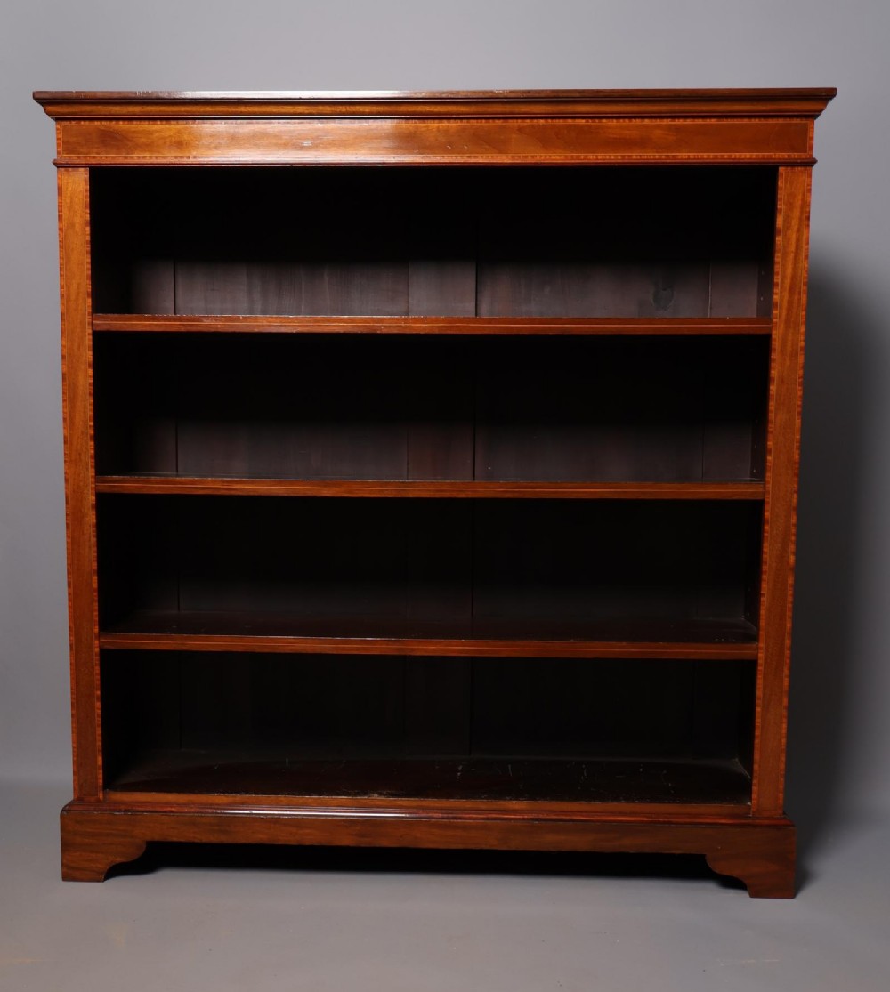 An Edwardian open-front mahogany bookcase featuring four wide shelves and decorative inlaid borders along the frame. View V