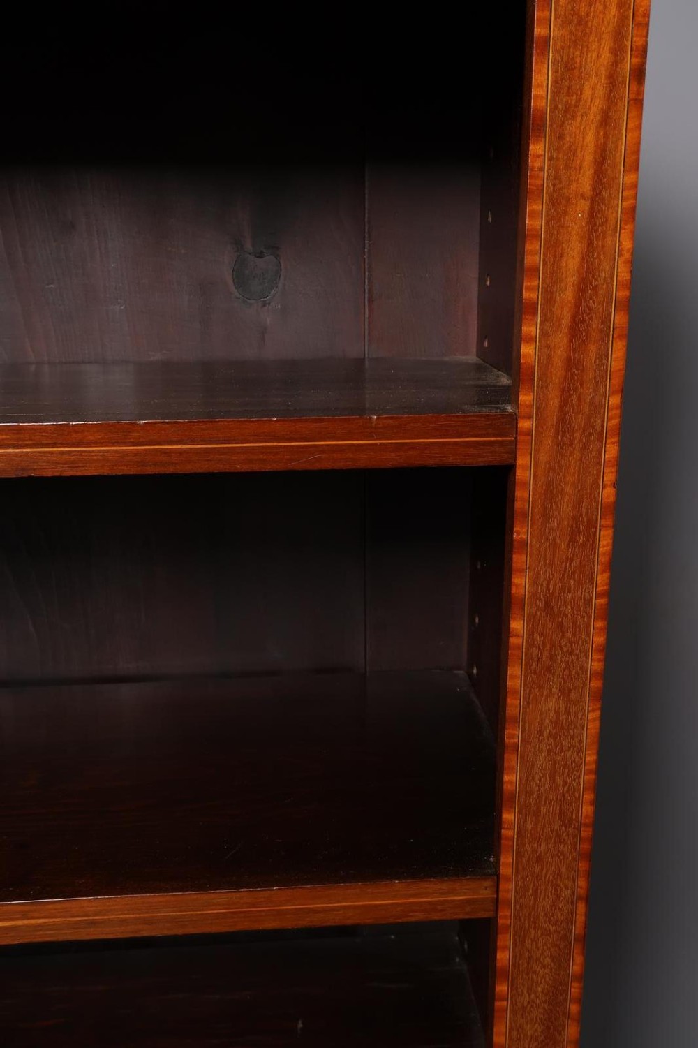 An Edwardian open-front mahogany bookcase featuring four wide shelves and decorative inlaid borders along the frame. View VII