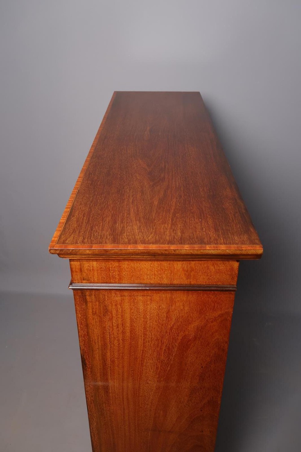 An Edwardian open-front mahogany bookcase featuring four wide shelves and decorative inlaid borders along the frame. View VIII