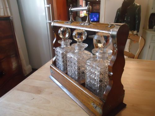 fig 1. FINE EDWARDIAN CUT GLASS THREE BOTTLE OAK AND PLATED TANTALUS WITH BRAMAH LOCK AND KEY