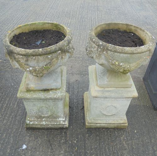 Pair of Weathered Sandstone Garden Urns on Stands
