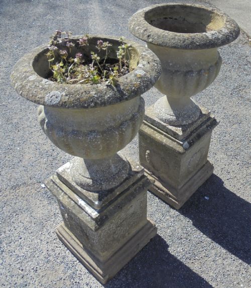 Pair of Weathered Sandstone Garden Urns on Stands