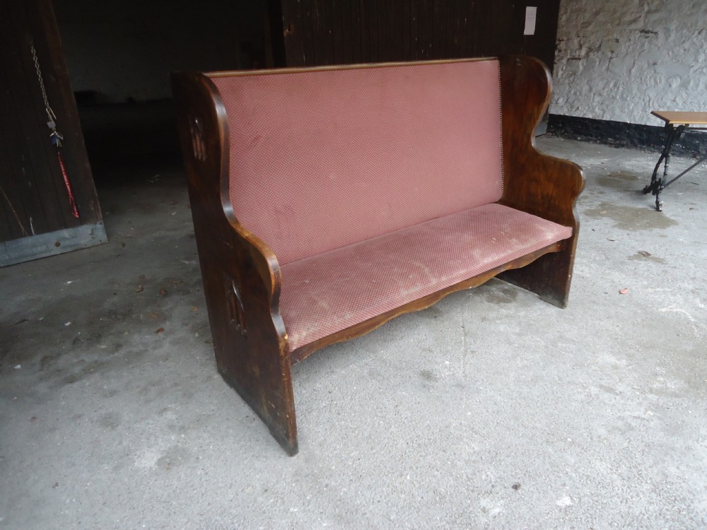 Upholstered oak settle from Glastonbury pub.