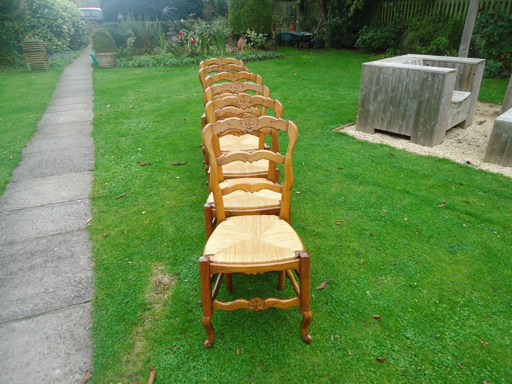 Set of six rush seated French ladder back chairs