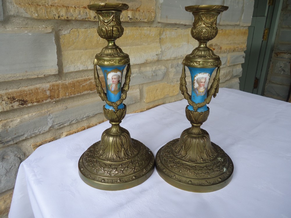 Pair gilded bronze candlesticks with Sevres panels and ornate swags.
