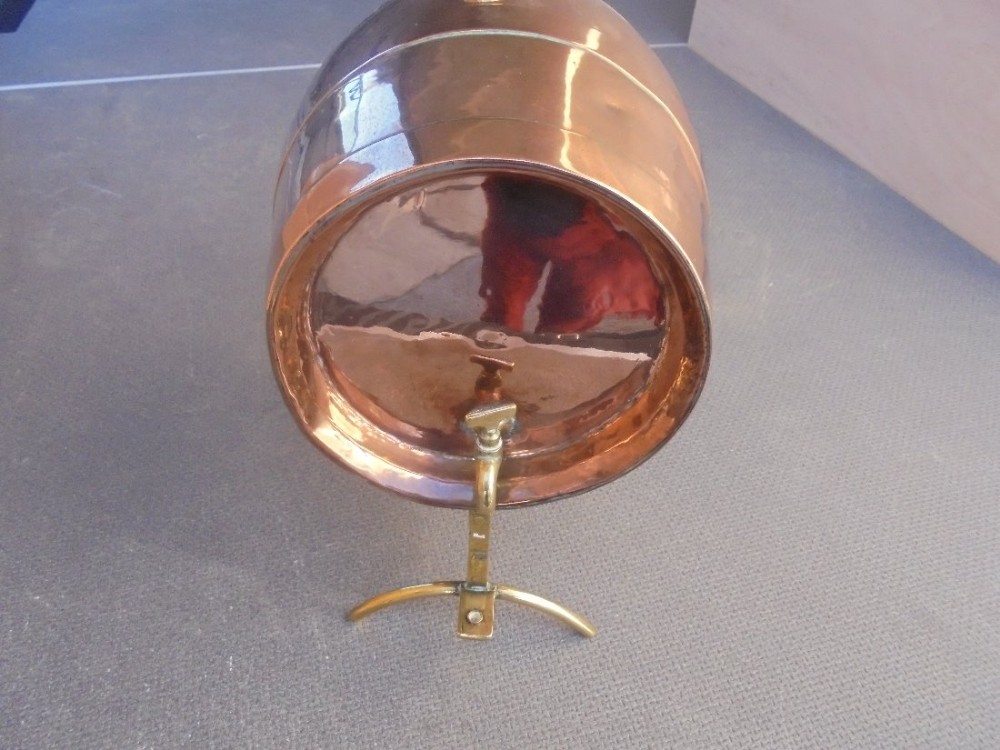 19th century copper and brass wine barrel on stand .