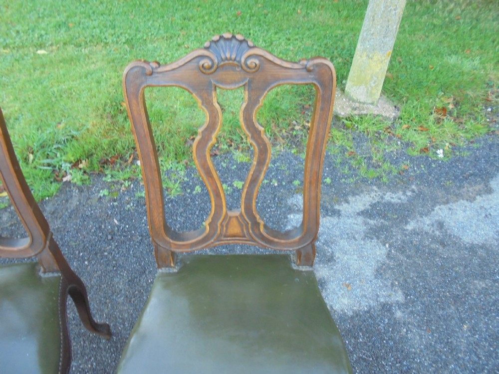Set of six French carved oak dining chairs with leather seats and high back View III