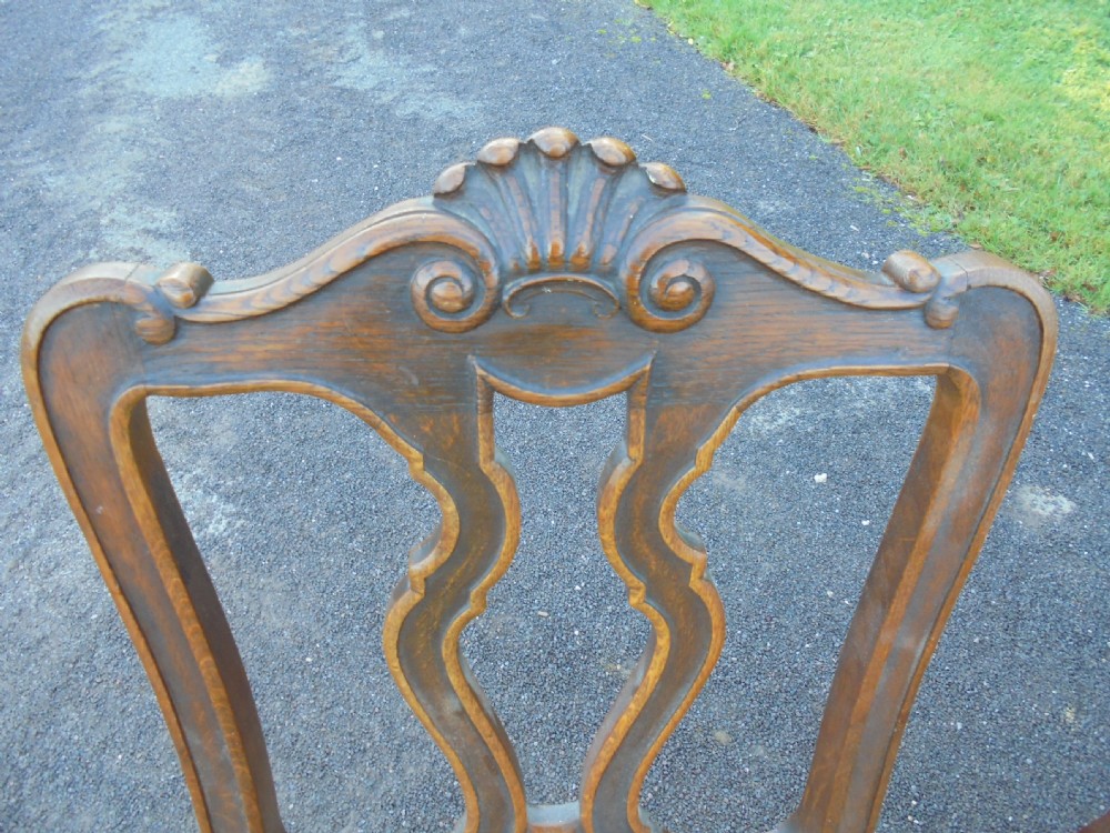 Set of six French carved oak dining chairs with leather seats and high back View V