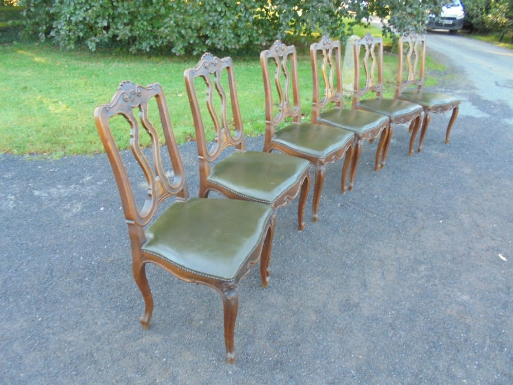 Set of six French carved oak dining chairs with leather seats and high back View VII