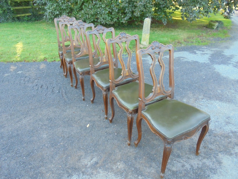 Set of six French carved oak dining chairs with leather seats and high back View VIII