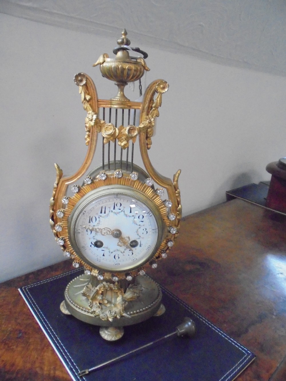 French Lyre shape gilded mantle clock with jewelled bezel