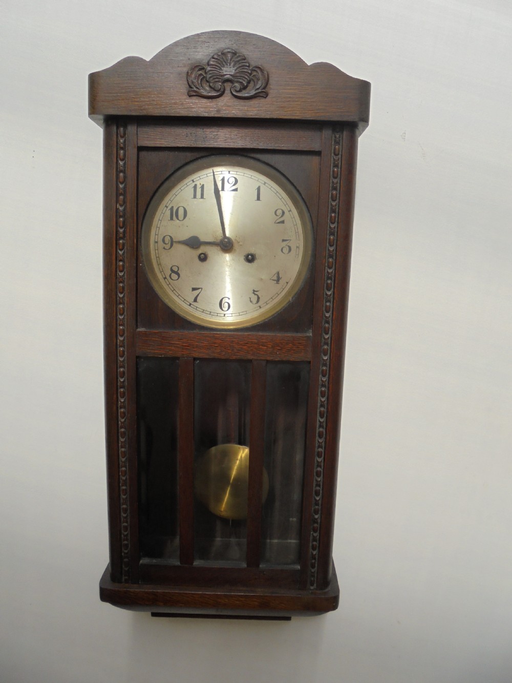 Eight day oak bevelled door wall clock