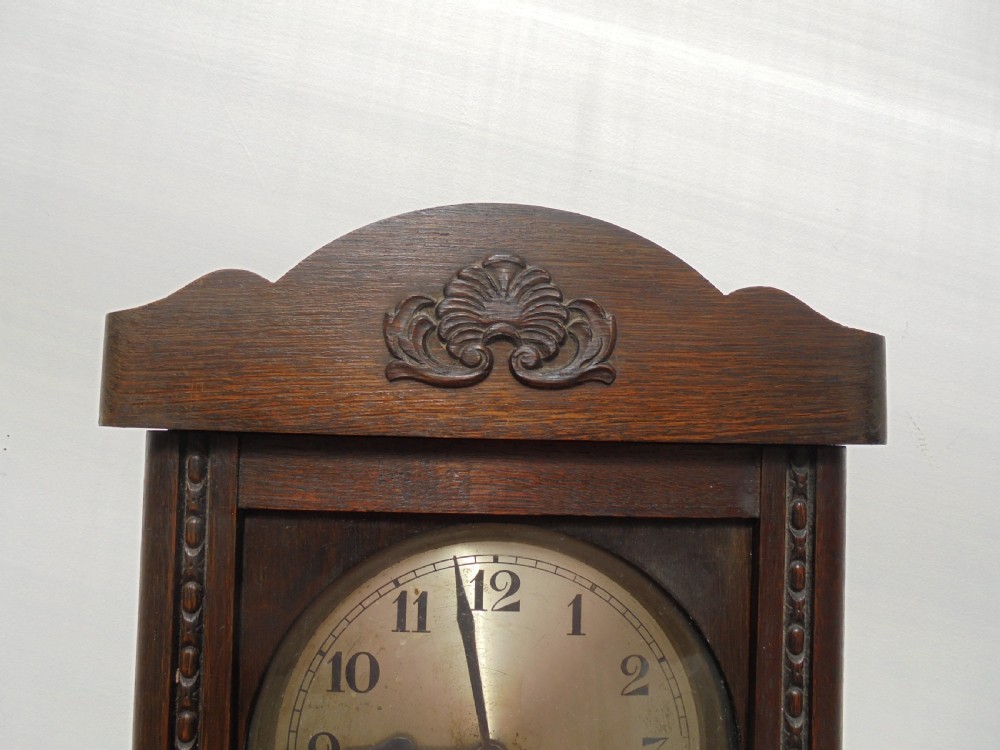 Eight day oak bevelled door wall clock View III