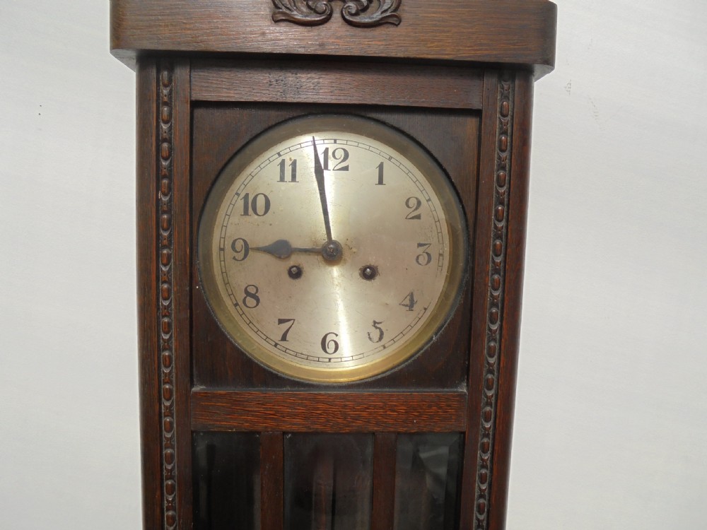 Eight day oak bevelled door wall clock View IV