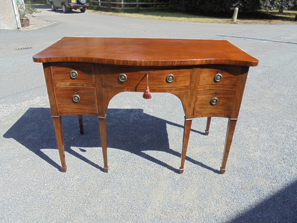 Classic 18th century mahogany serpentine sideboard