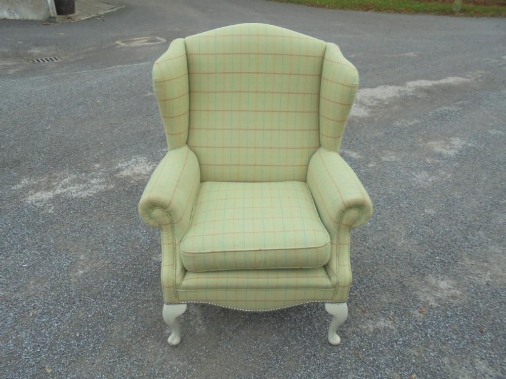 Upholstered winged armchair