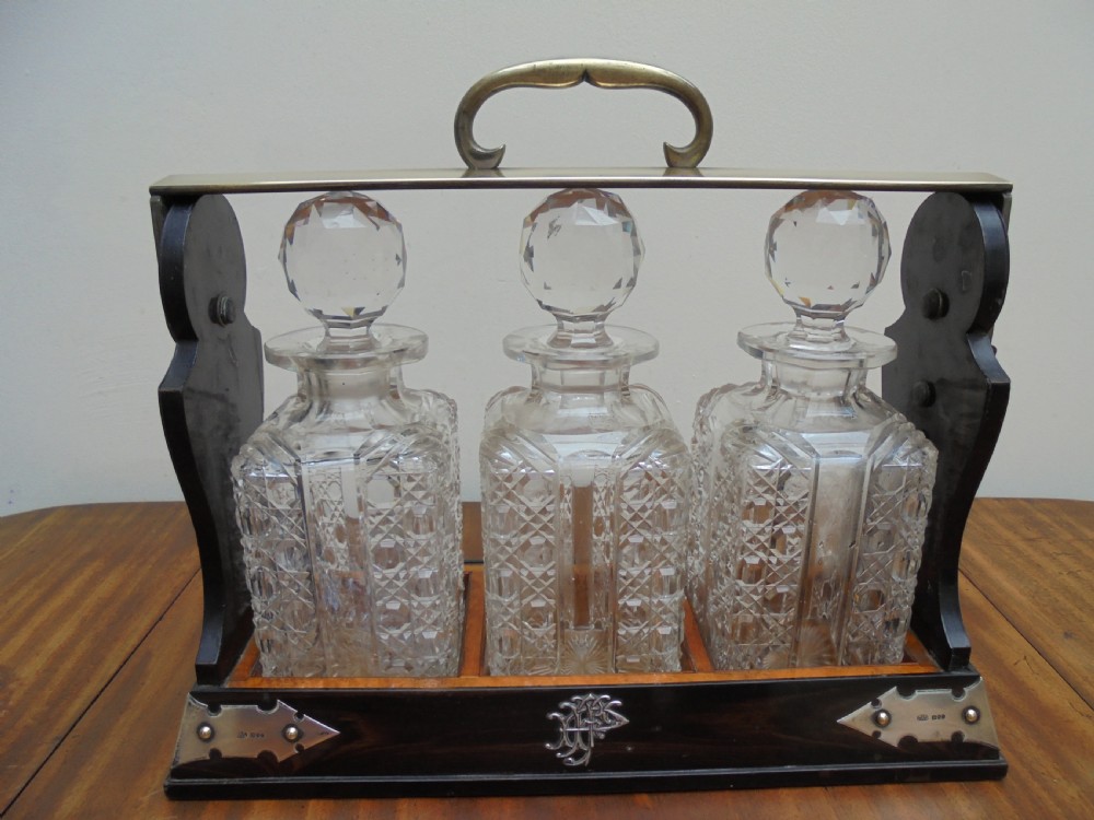 Betjemanns coromandel tantalus three bottle silver mounted 