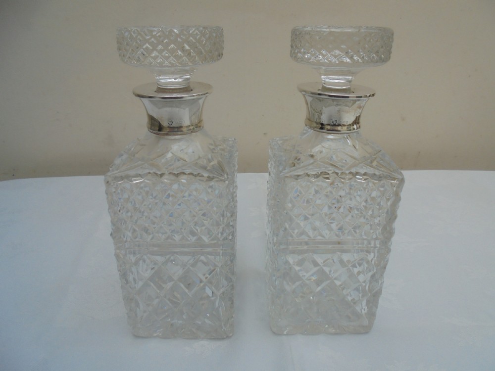 Pair of cut glass, silver top square decanters. View VI
