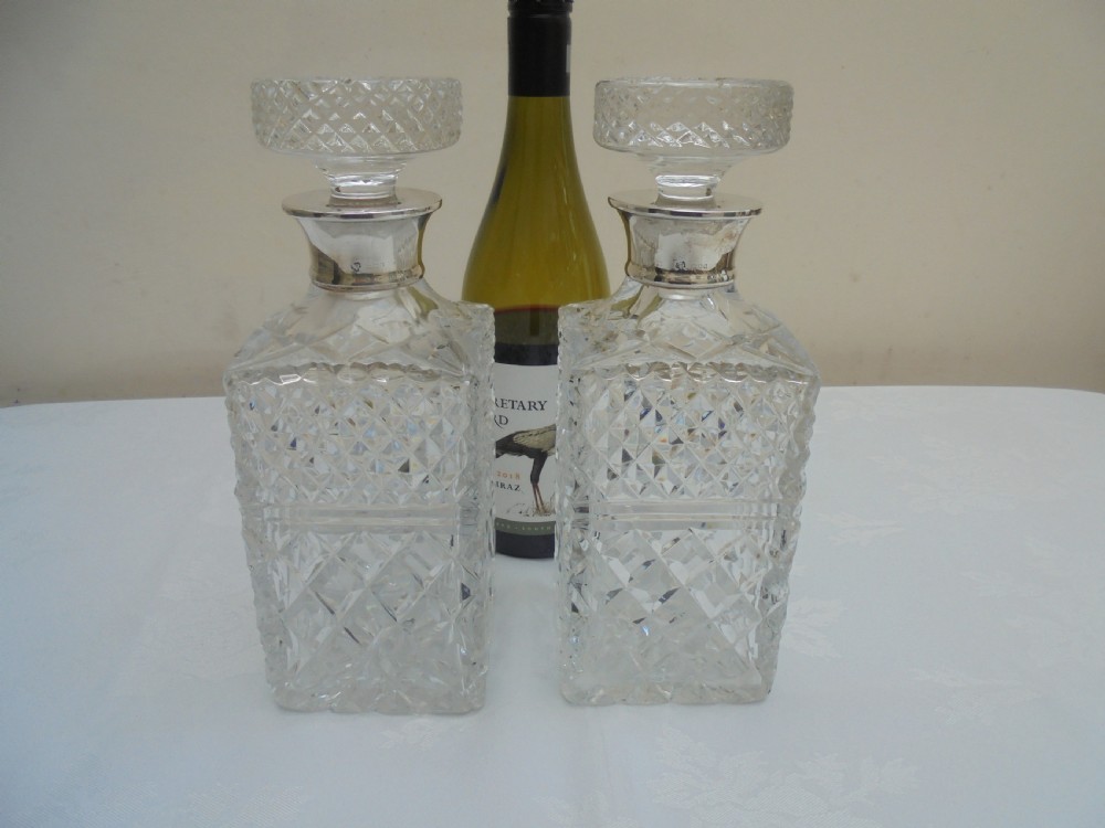 Pair of cut glass, silver top square decanters. View VIII