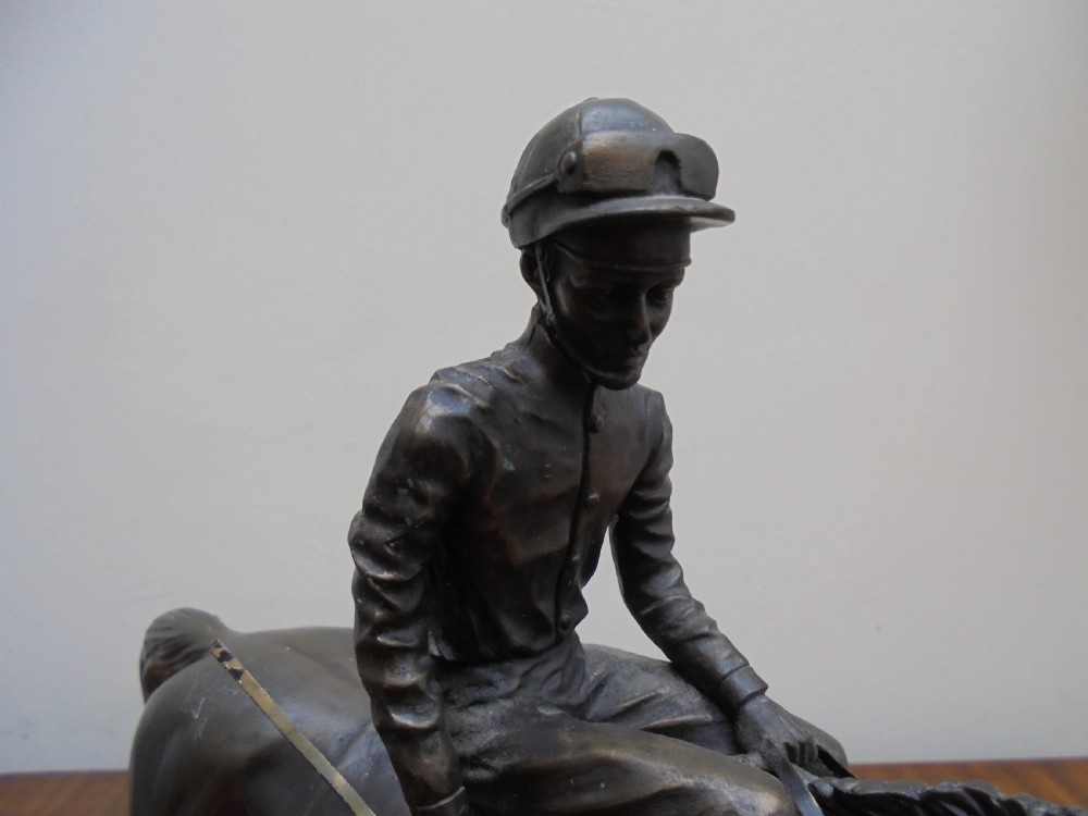 Bronzed jockey on racehorse View III