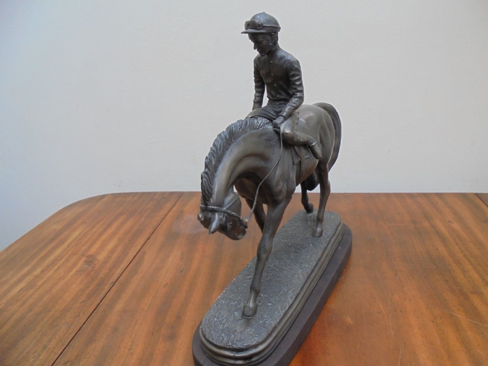 Bronzed jockey on racehorse View IV